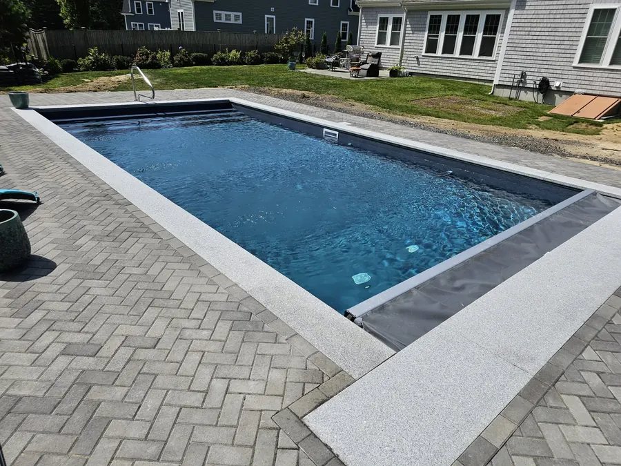 Pool with herringbone paver deck