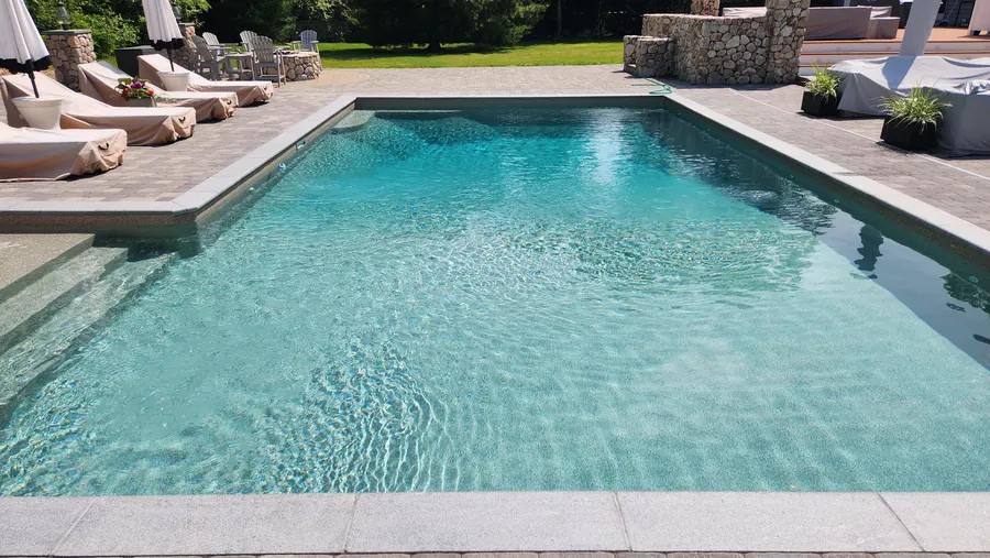 Finished gunite pool with turquoise water and paver deck